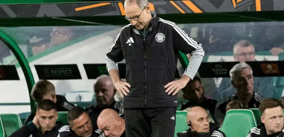 Coach looking down during match on the sidelines
