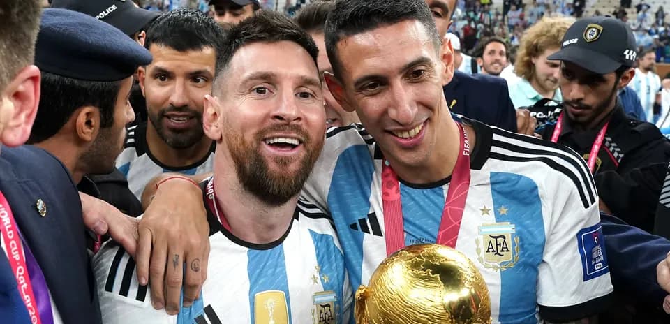Messi and Di María celebrating with World Cup trophy