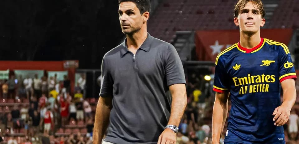 Coach and player walking off the pitch after match