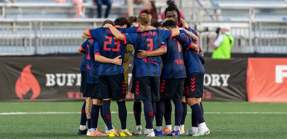 Players huddling before the match