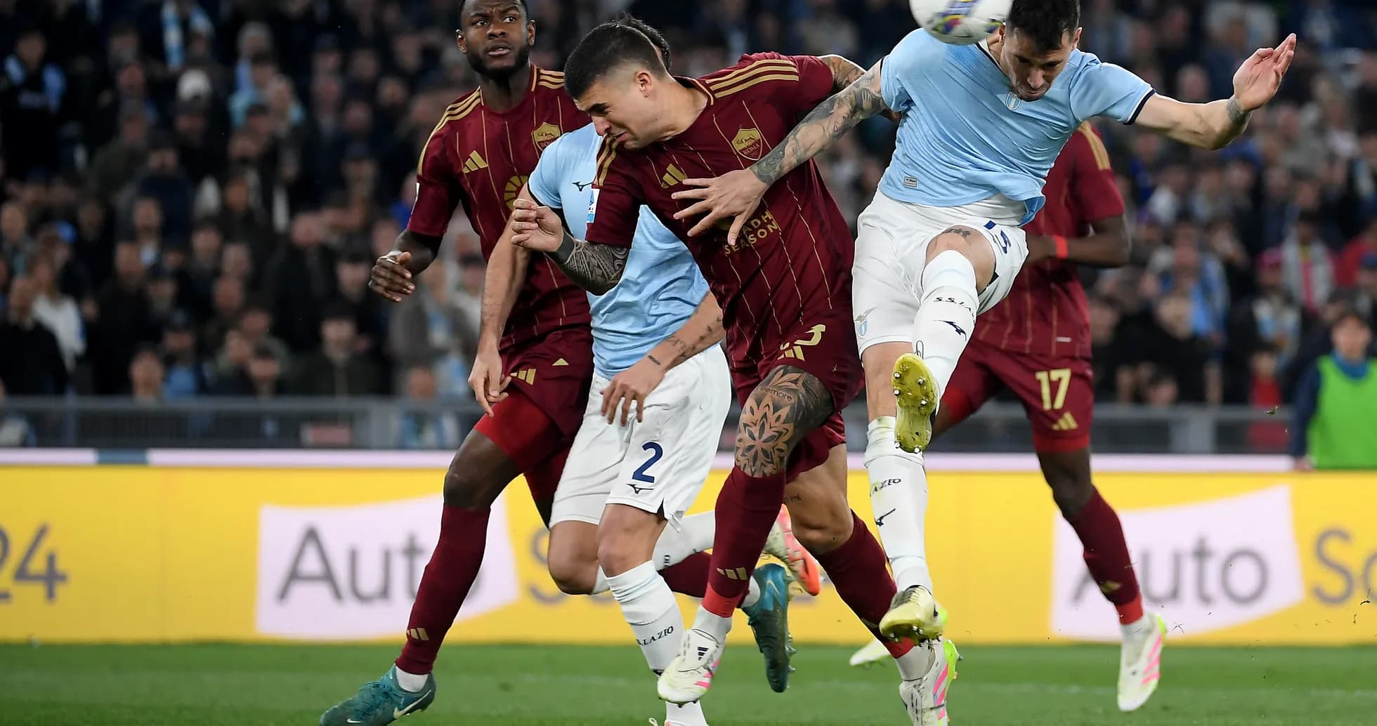 Players contesting for the ball during AS Roma vs Lazio