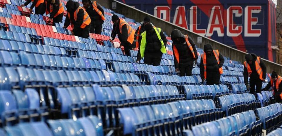 Staff cleaning stadium seats at Crystal Palace