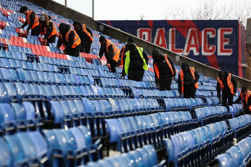 Staff cleaning stadium seats at Crystal Palace