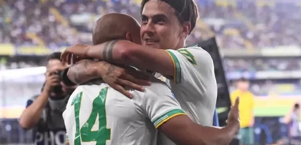 Players celebrating with an embrace after a match