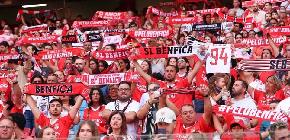 Benfica fans celebrating with scarves in stadium
