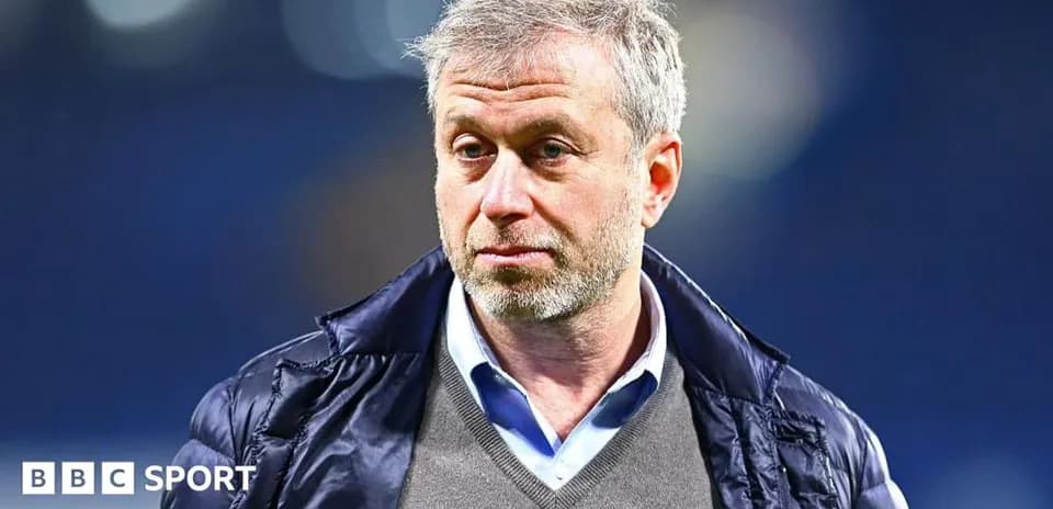 Man wearing a jacket at a sports venue