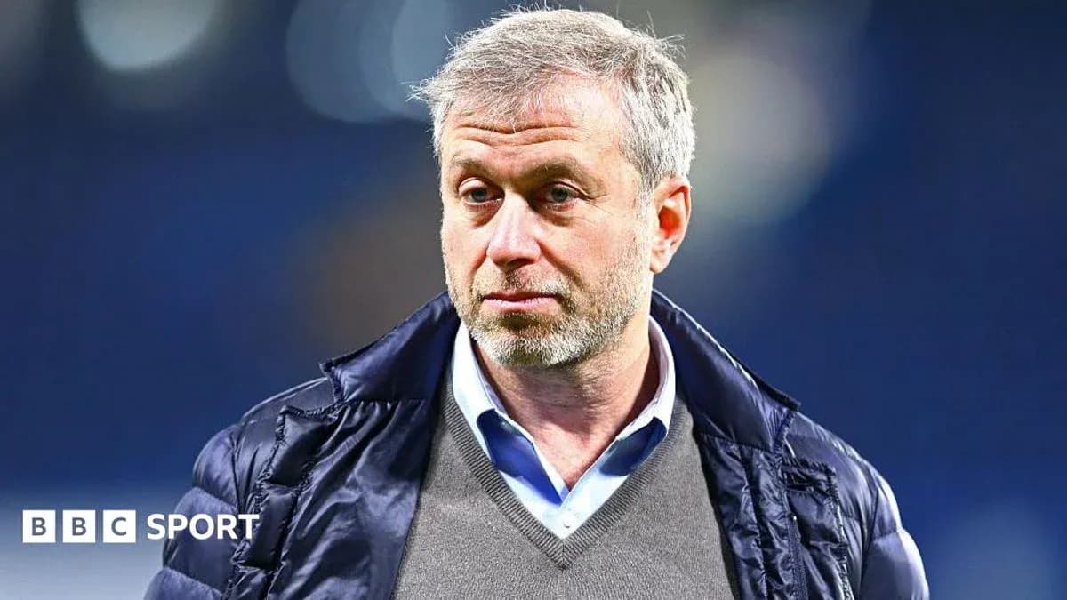 Man wearing a jacket at a sports venue