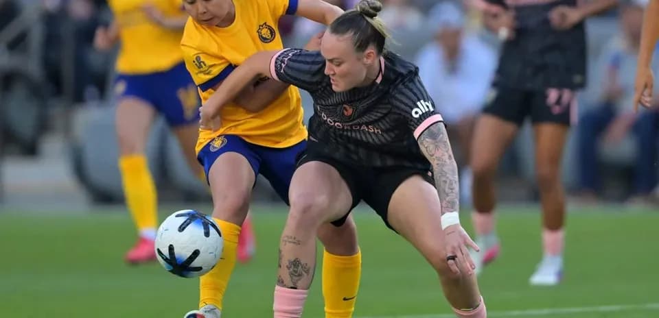 Players competing for the ball during NWSL match