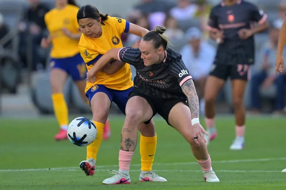 Players competing for the ball during NWSL match