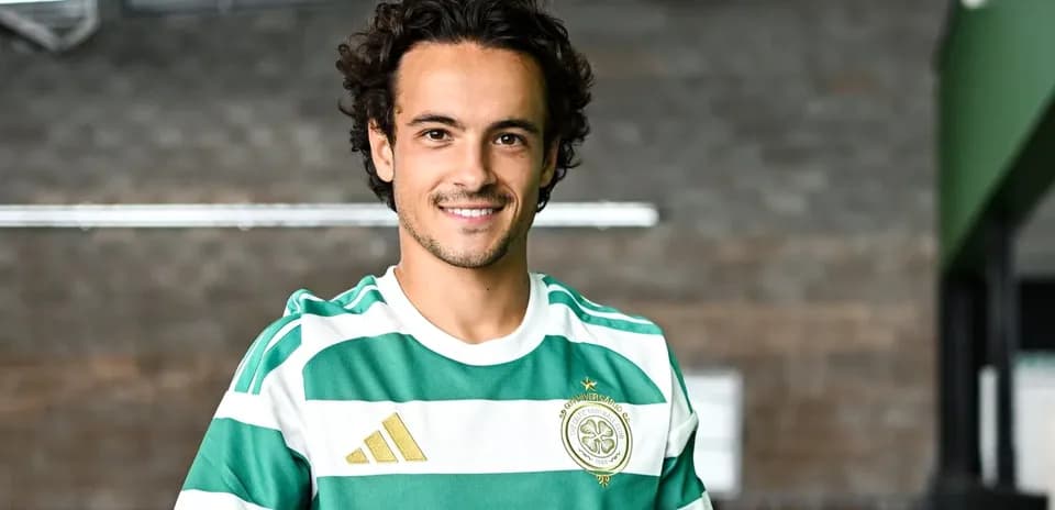 Player in Celtic FC kit smiling at camera