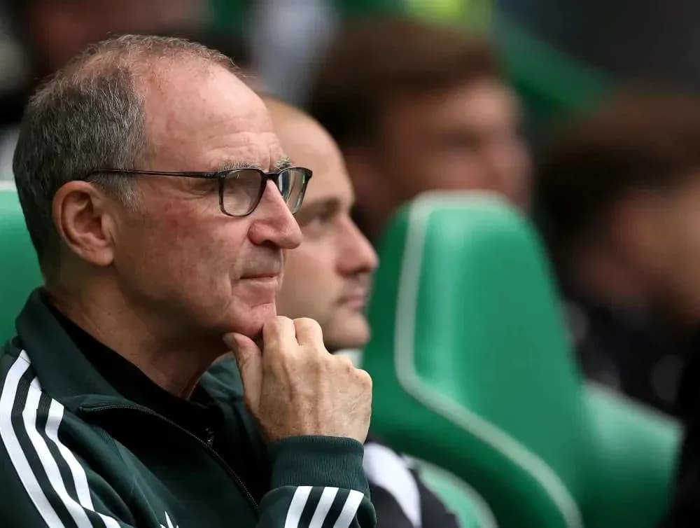 Coach observing from the sidelines during match