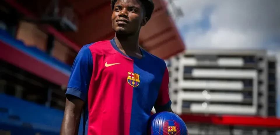 Player in Barcelona kit holding a football