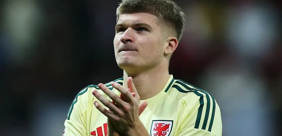 Player applauding fans in yellow jersey