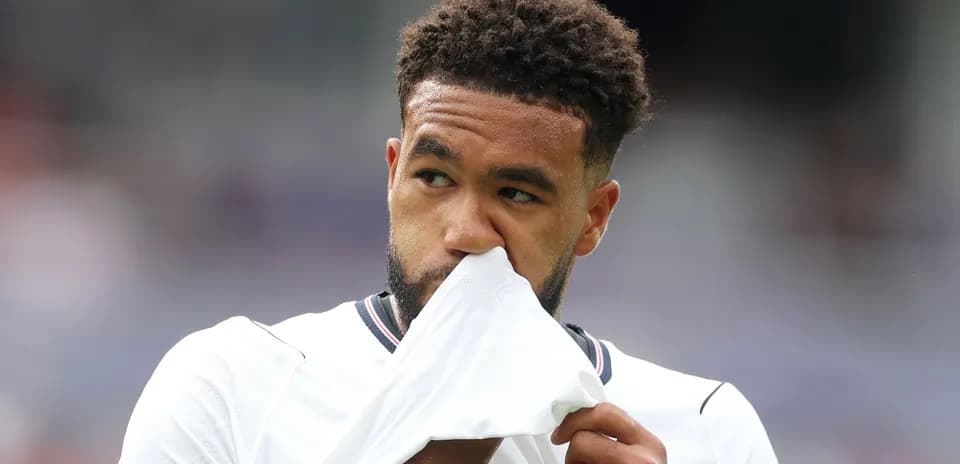 Player holding shirt while looking thoughtful