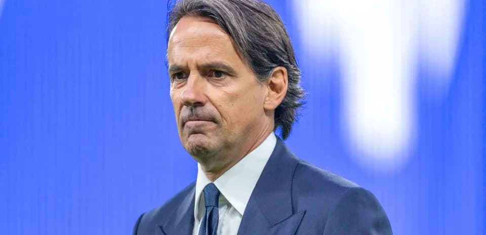 Coach standing on stage with serious expression