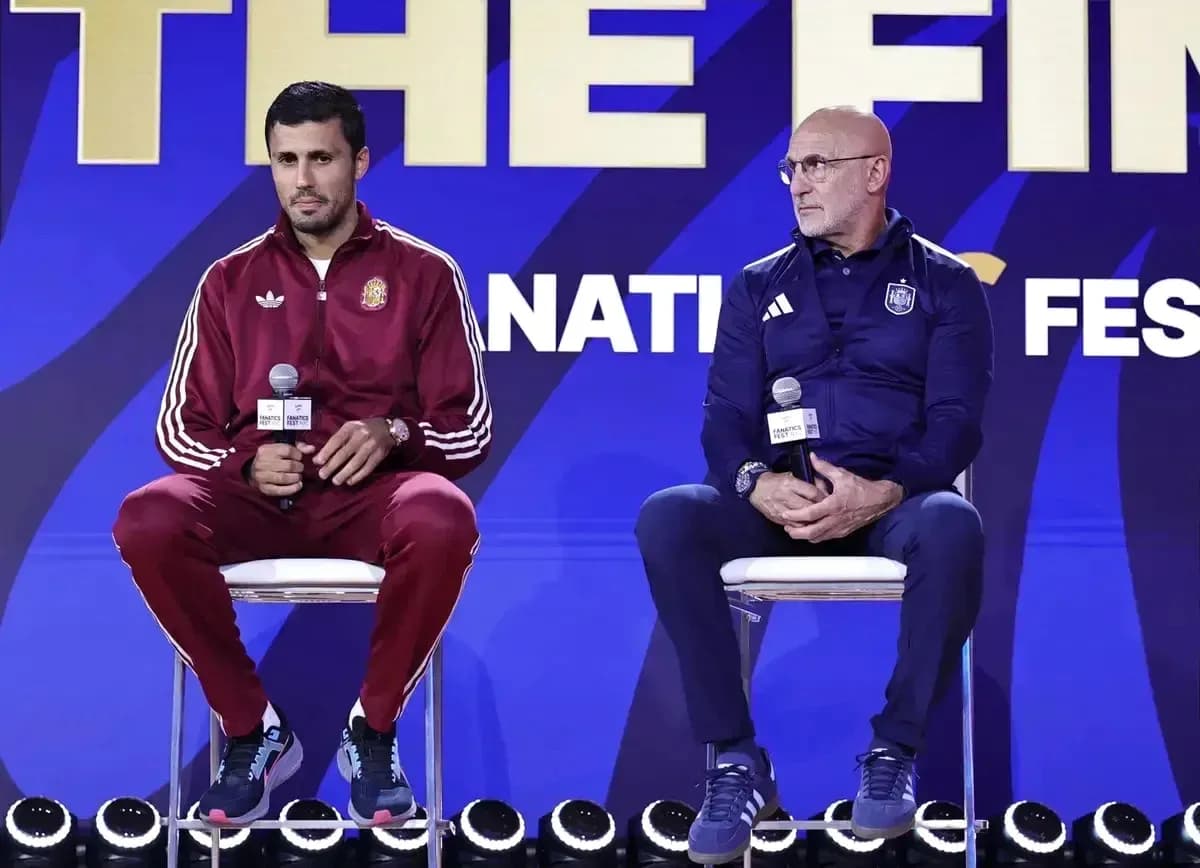 Coaches seated at press conference with microphones