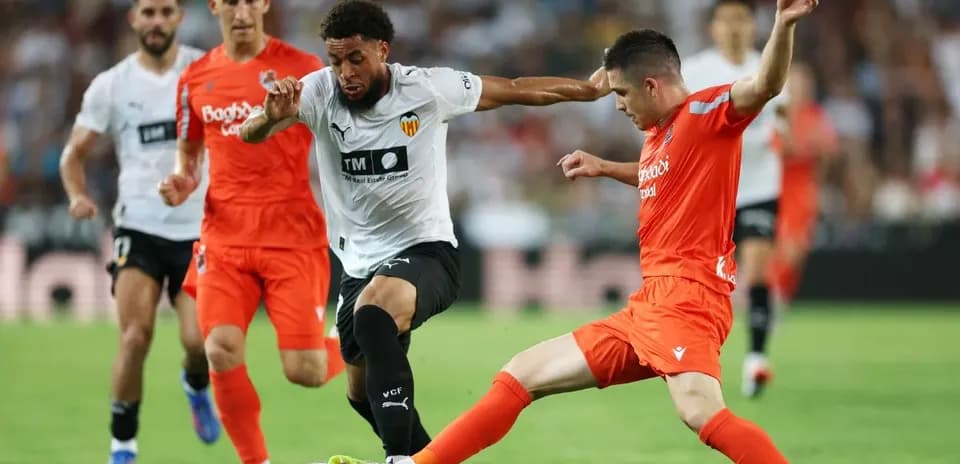 Real Sociedad and Valencia players contesting for the ball