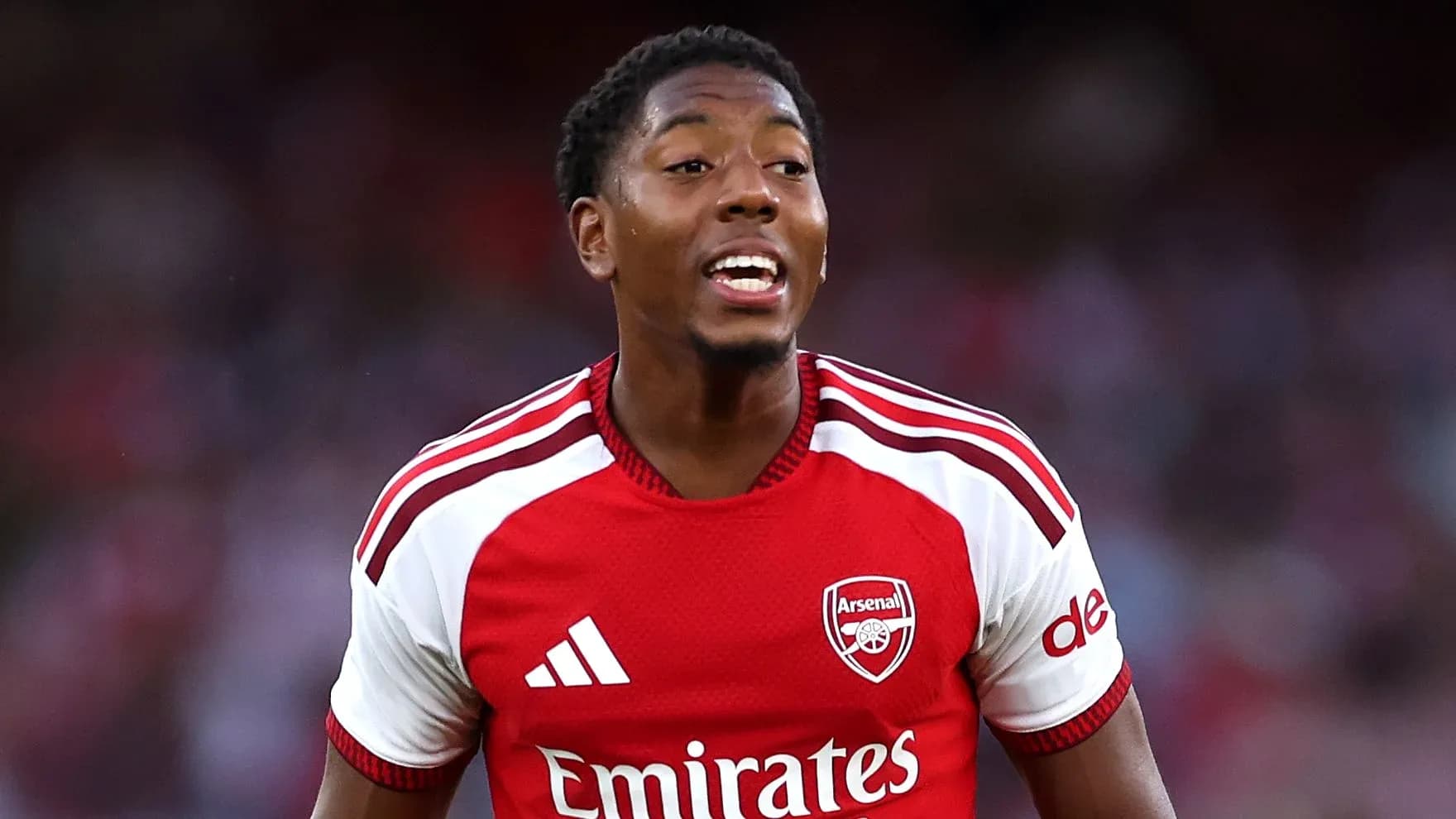 Player celebrating in Arsenal's red home kit