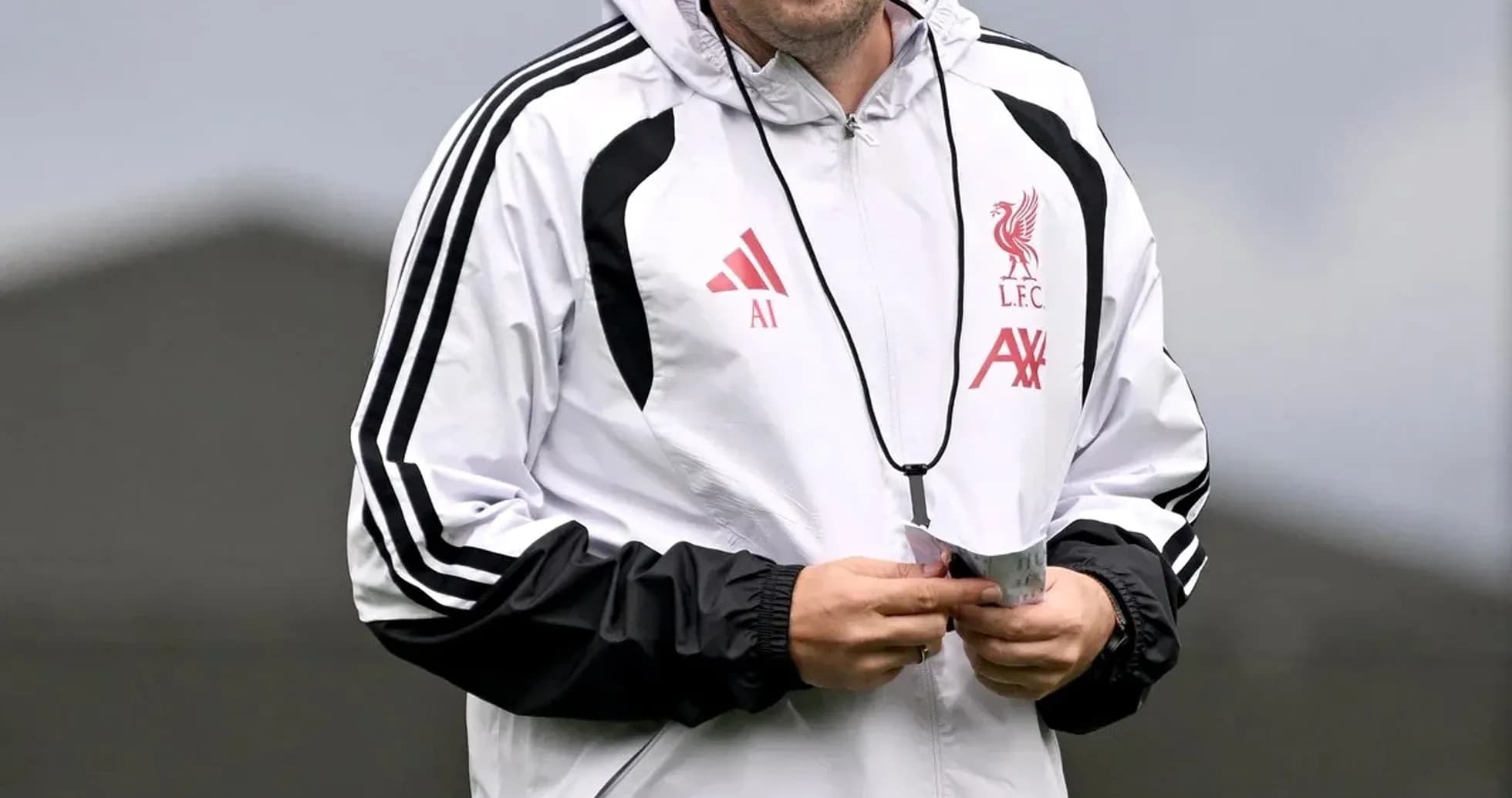 Coach in Liverpool training gear smiling during session