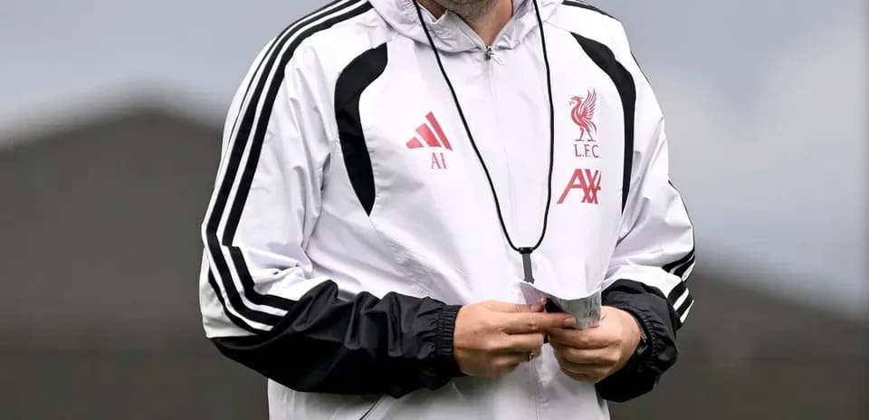 Coach in Liverpool training gear smiling during session