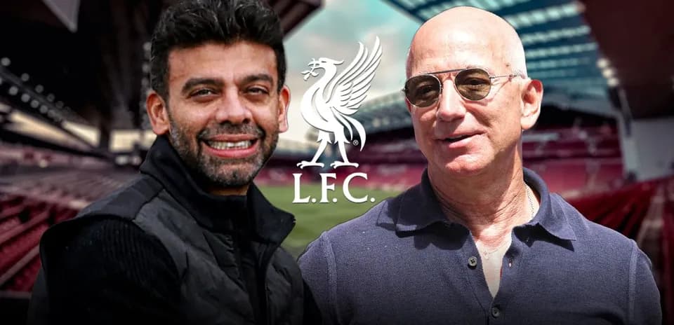 Two men posing at Anfield stadium with LFC logo
