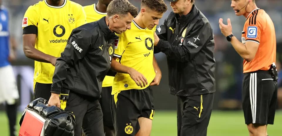 Borussia Dortmund player receiving medical attention on field