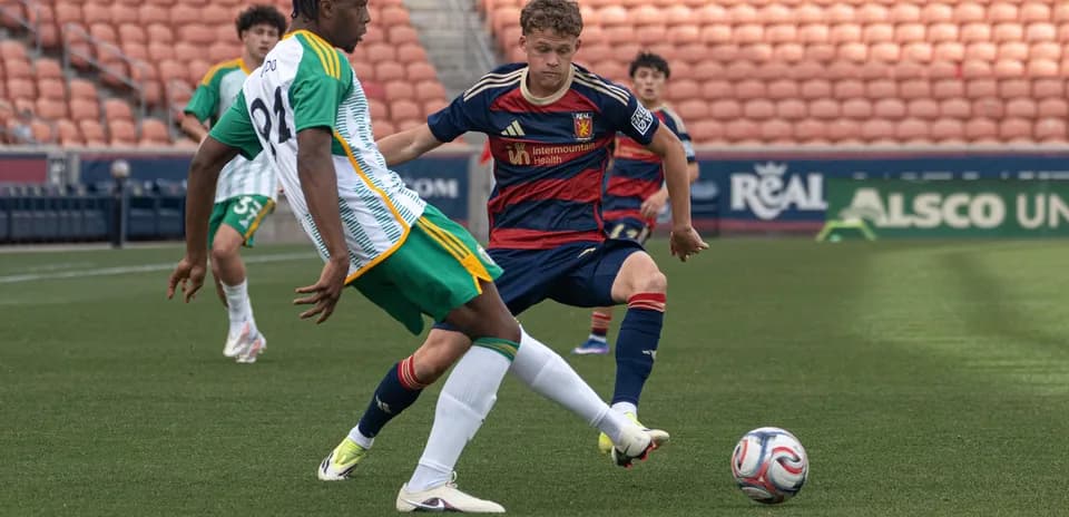 Two players competing for the ball during match