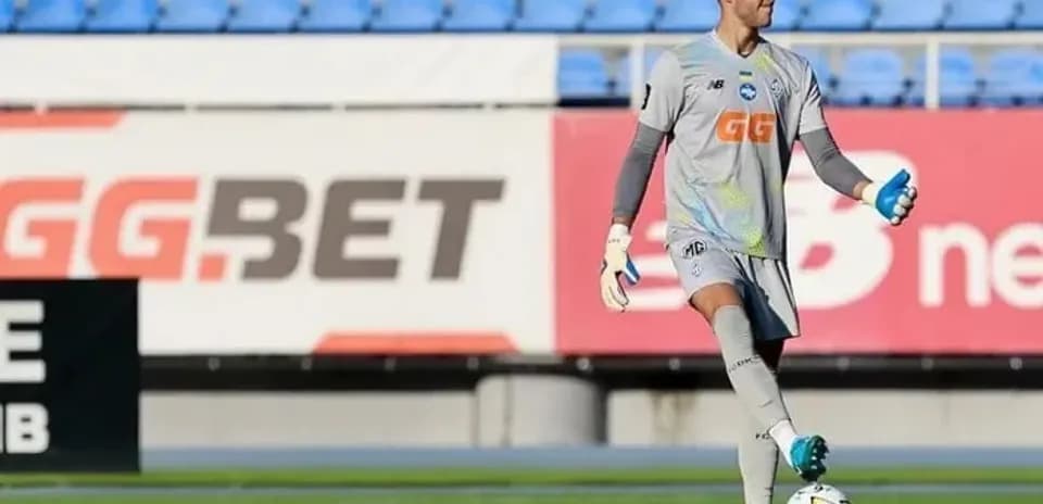 Goalkeeper in gray kit preparing for play