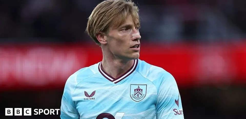 Player wearing light blue Burnley jersey on field