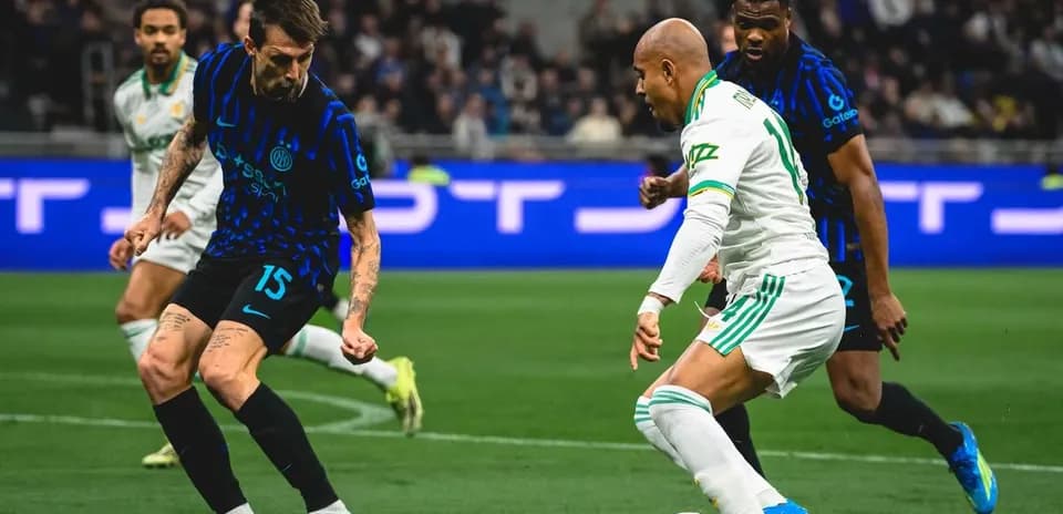 Inter player challenging AS Roma opponent