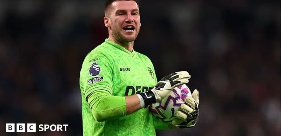 Goalkeeper in green jersey holding a football
