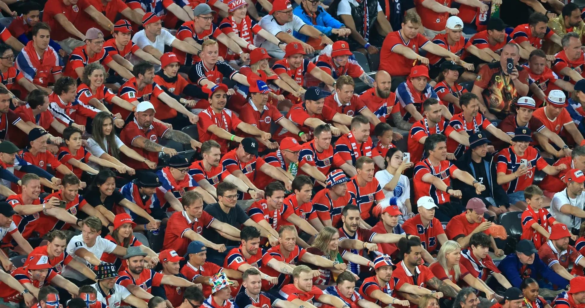 Crowd of fans wearing red jerseys in stadium