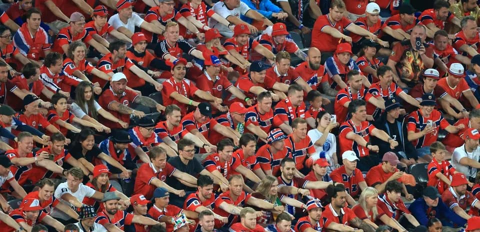 Crowd of fans wearing red jerseys in stadium