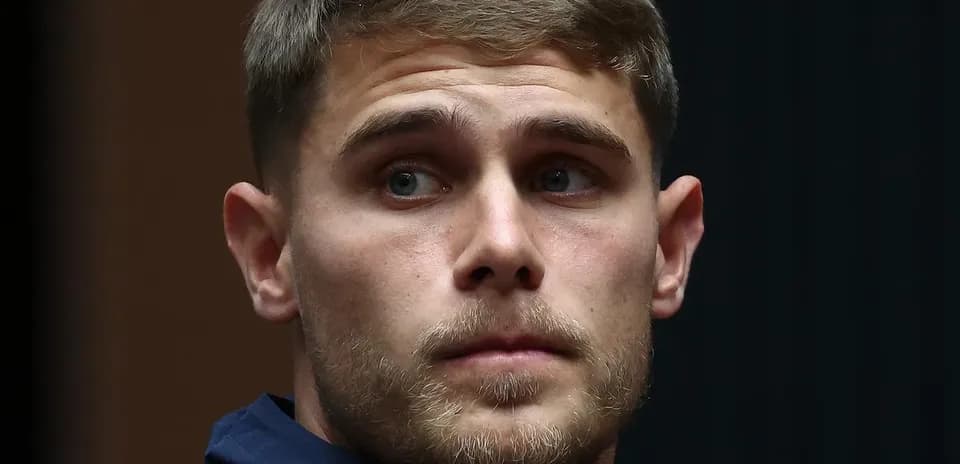 Athlete in navy jacket looking to the side