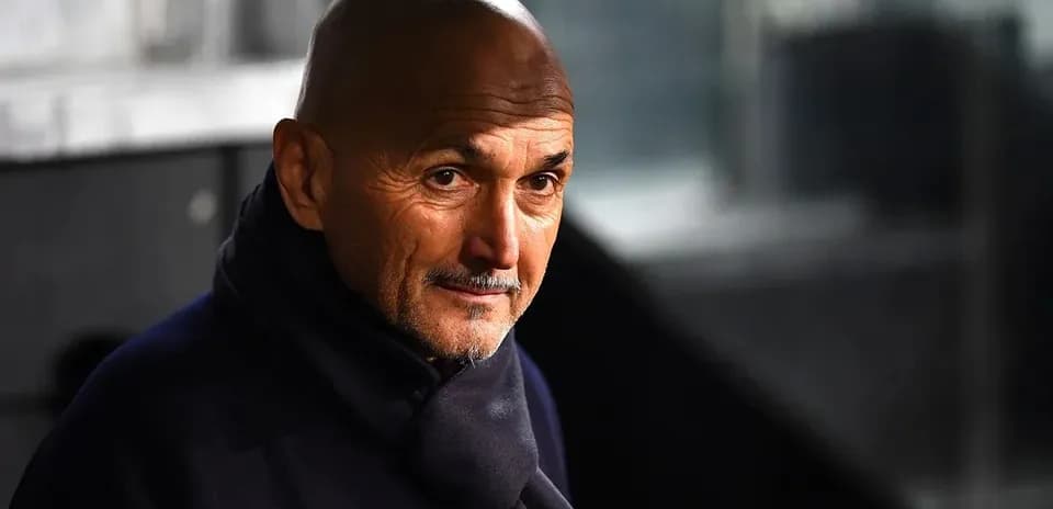 Coach in a dark coat during a match