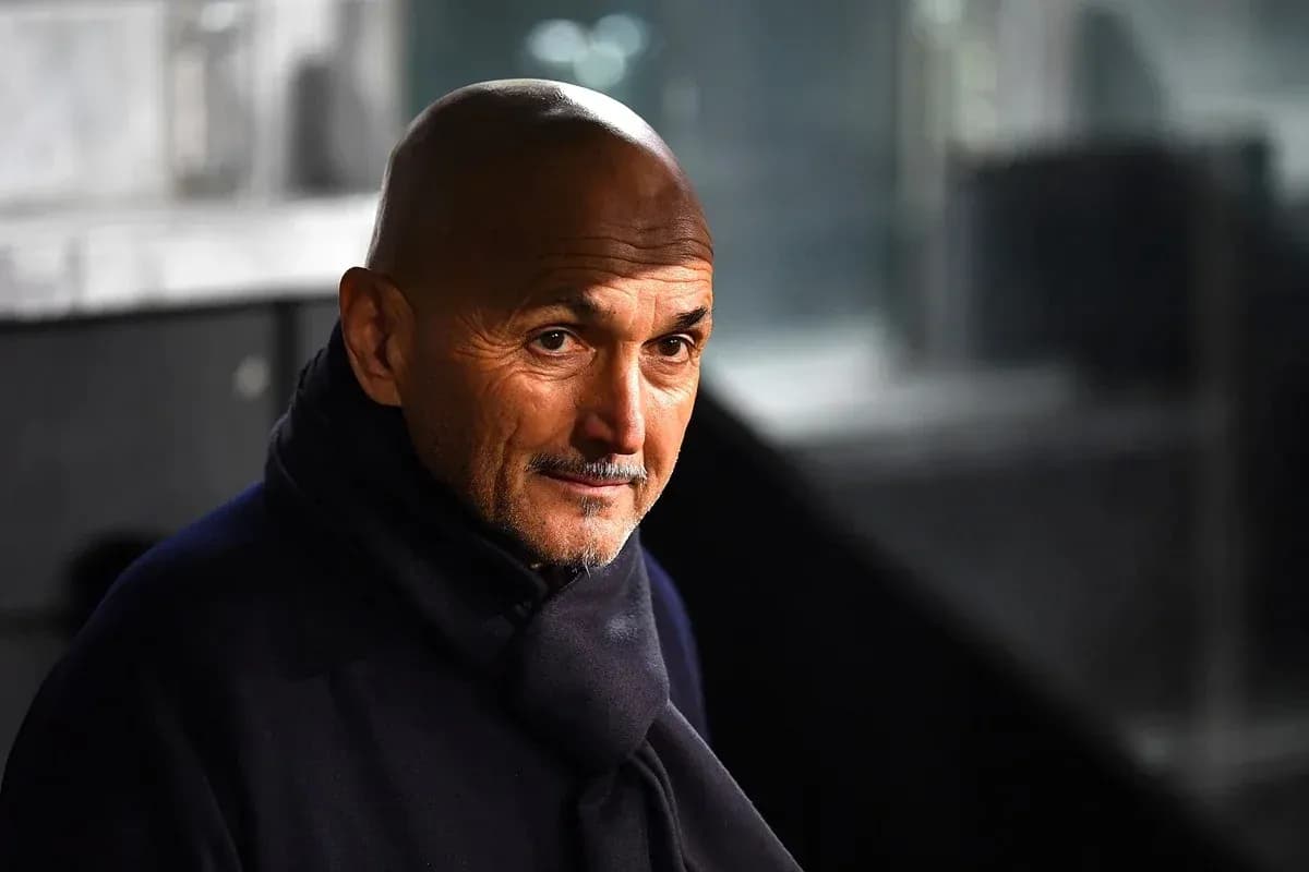 Coach in a dark coat during a match