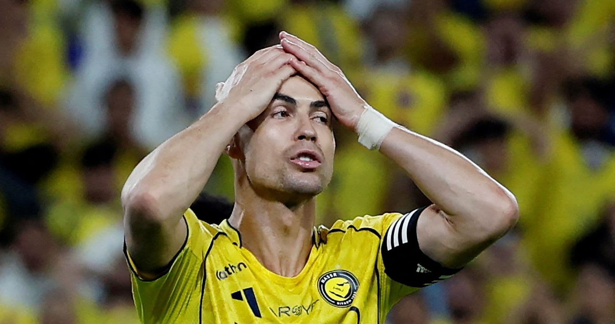 Player in yellow jersey holding head during match