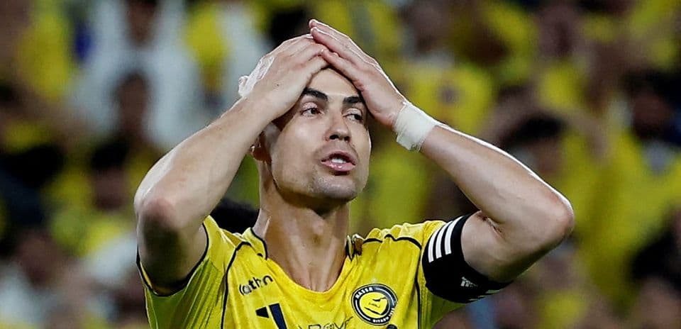 Player in yellow jersey holding head during match