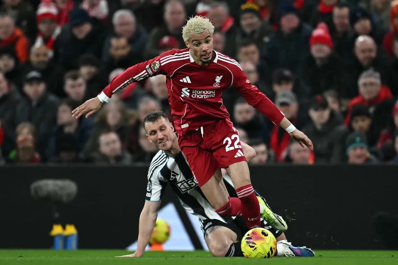 Liverpool player tackling Newcastle opponent