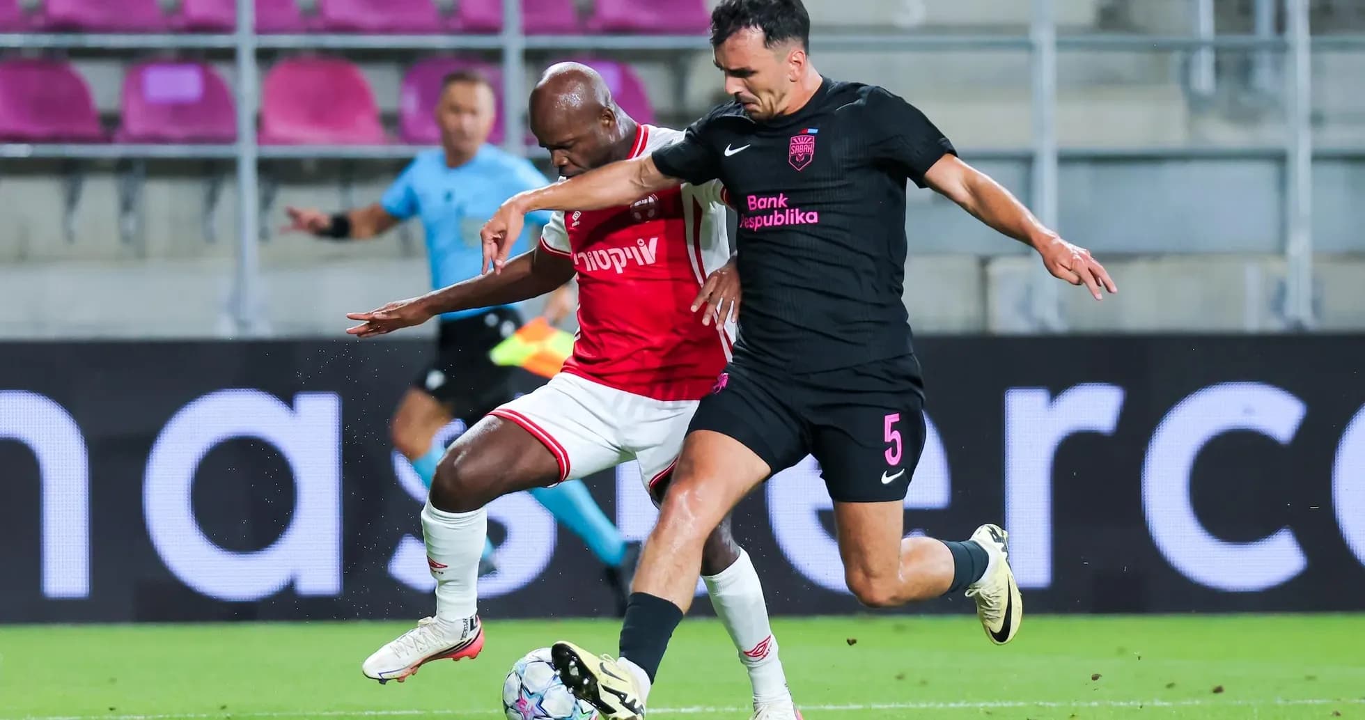 Players competing for the ball during UEFA match