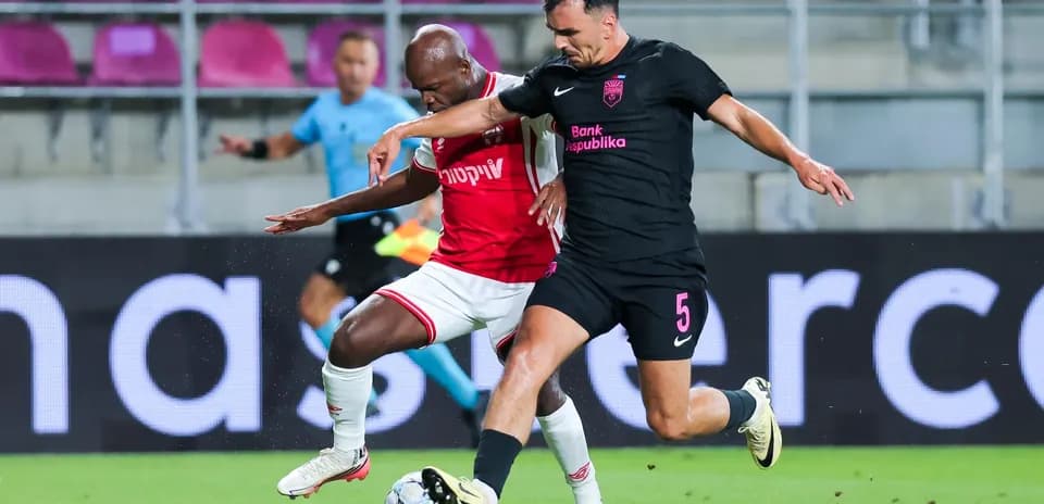 Players competing for the ball during UEFA match