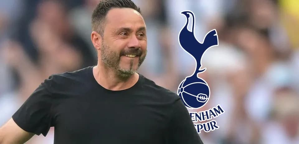 Manager smiling during match with Tottenham Hotspur logo