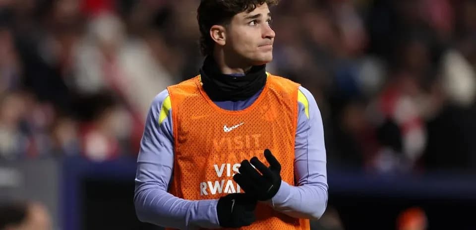 Player in warm-up vest on the sidelines