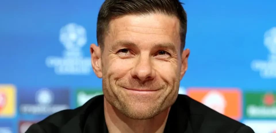 Manager smiling at press conference podium