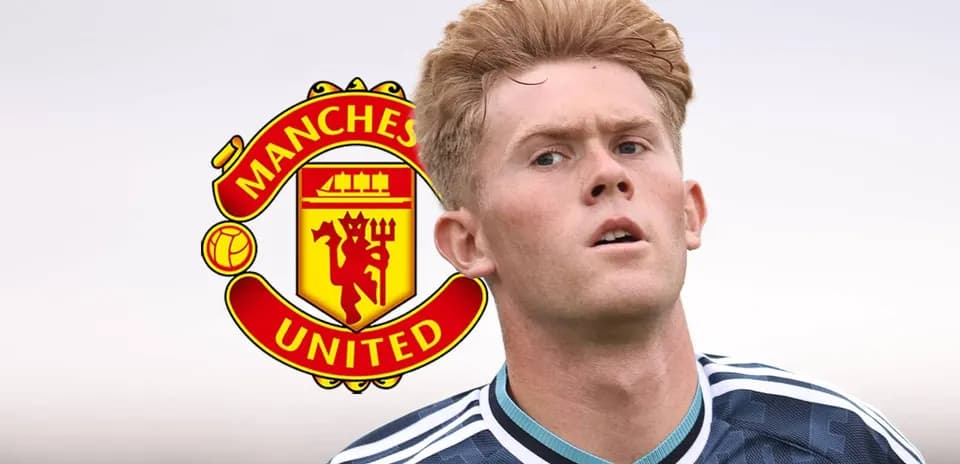 Player in Manchester United kit looking ahead