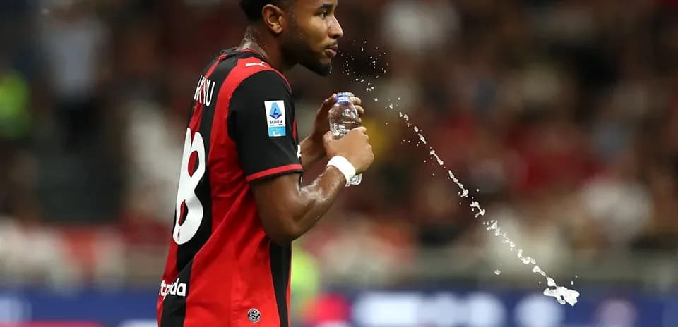 Player drinking water during match with jersey number 8
