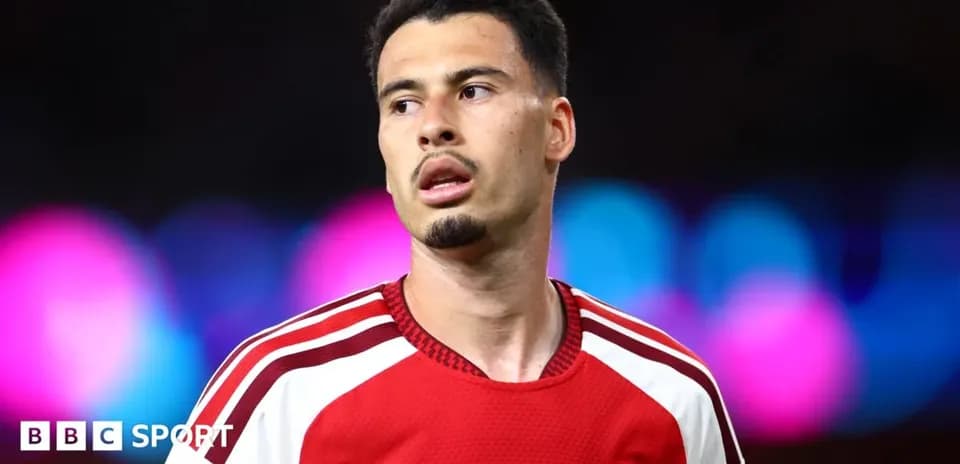 Football player wearing Arsenal kit during match