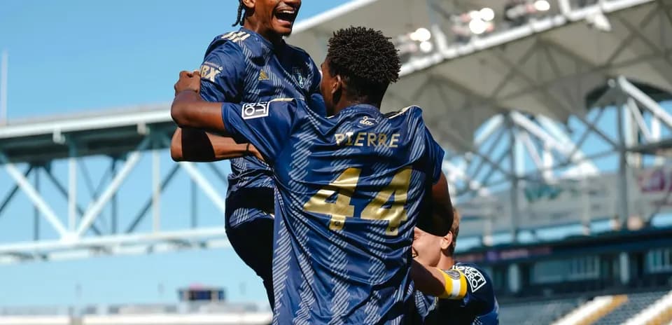 Players celebrating a goal during match