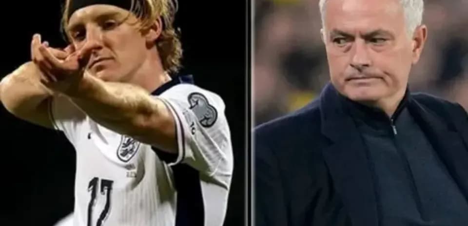 Football player celebrating and manager observing match