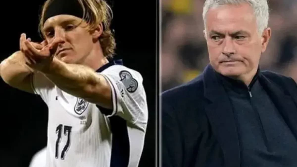 Football player celebrating and manager observing match